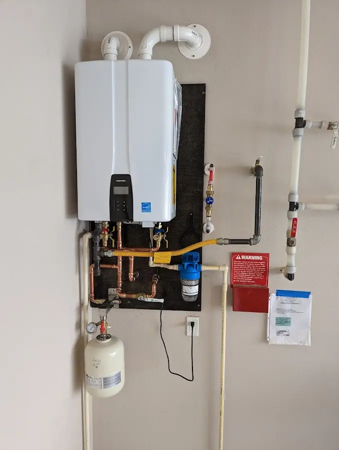 Professional plumber installing copper piping in a Ellwood City home